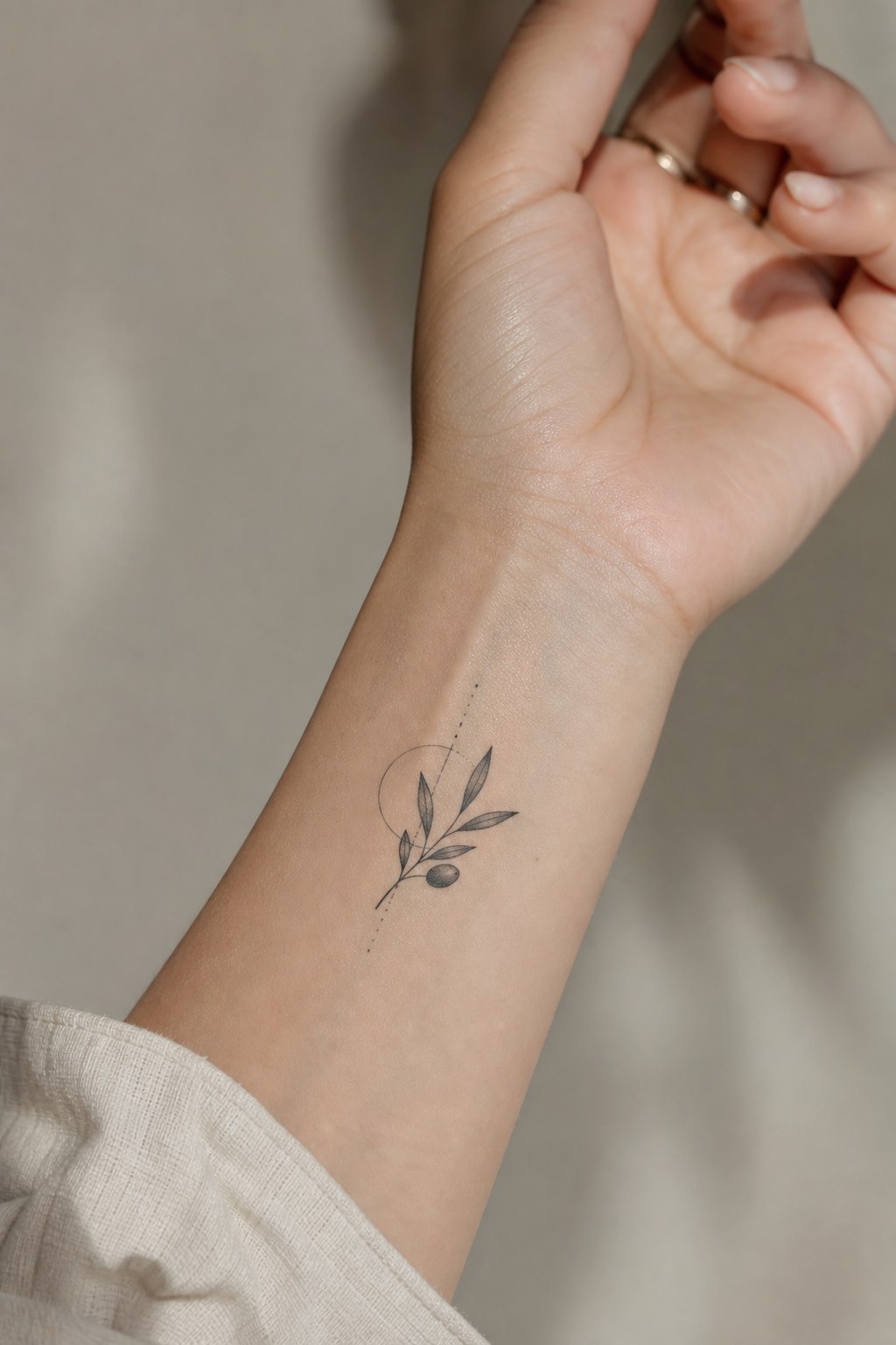 Geometric olive motif tattoo